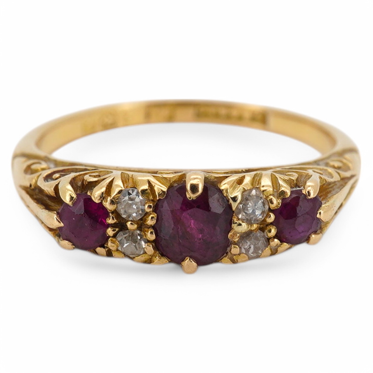 An Edwardian 18ct gold, three stone ruby and four stone diamond set half hoop ring, size K, gross weight 3.4 grams. Condition - fair